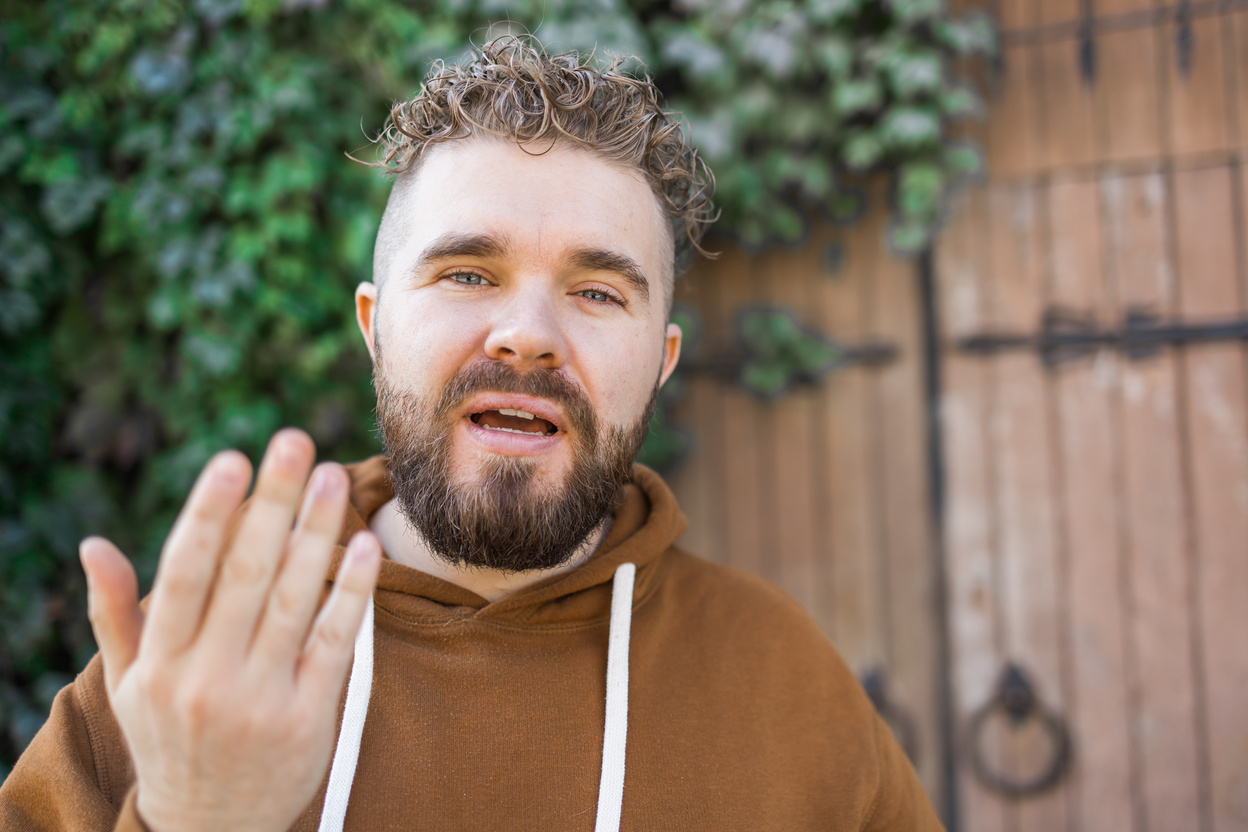 Handsome Curly Man Takes a Video of Himself - Video Blog and Youth Blogger Concept